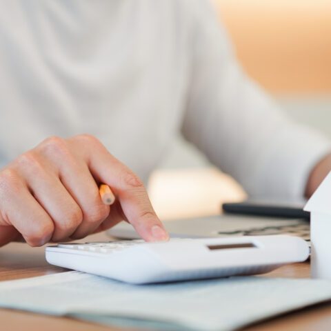 Man on a calculator working out finances 
